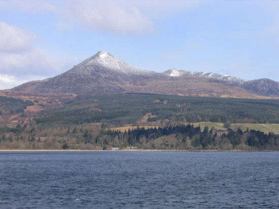 A snow-capped Goatfell with Brodick castle at the lower left corner. 