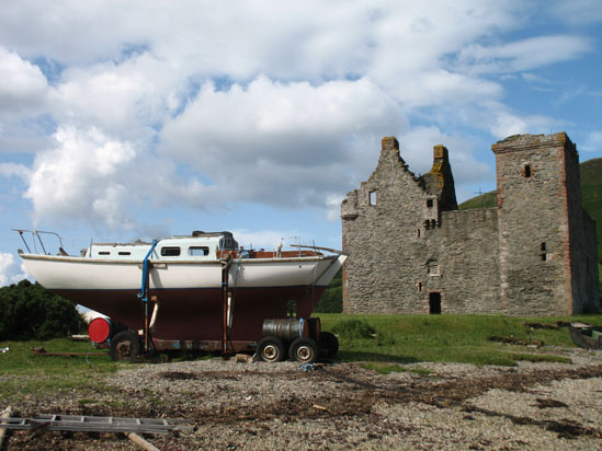 Picture of   Lochranza Castle with small boat infront of it is shown on this page.