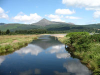 Two Swans on Brodick Beach with Goatfell in the background